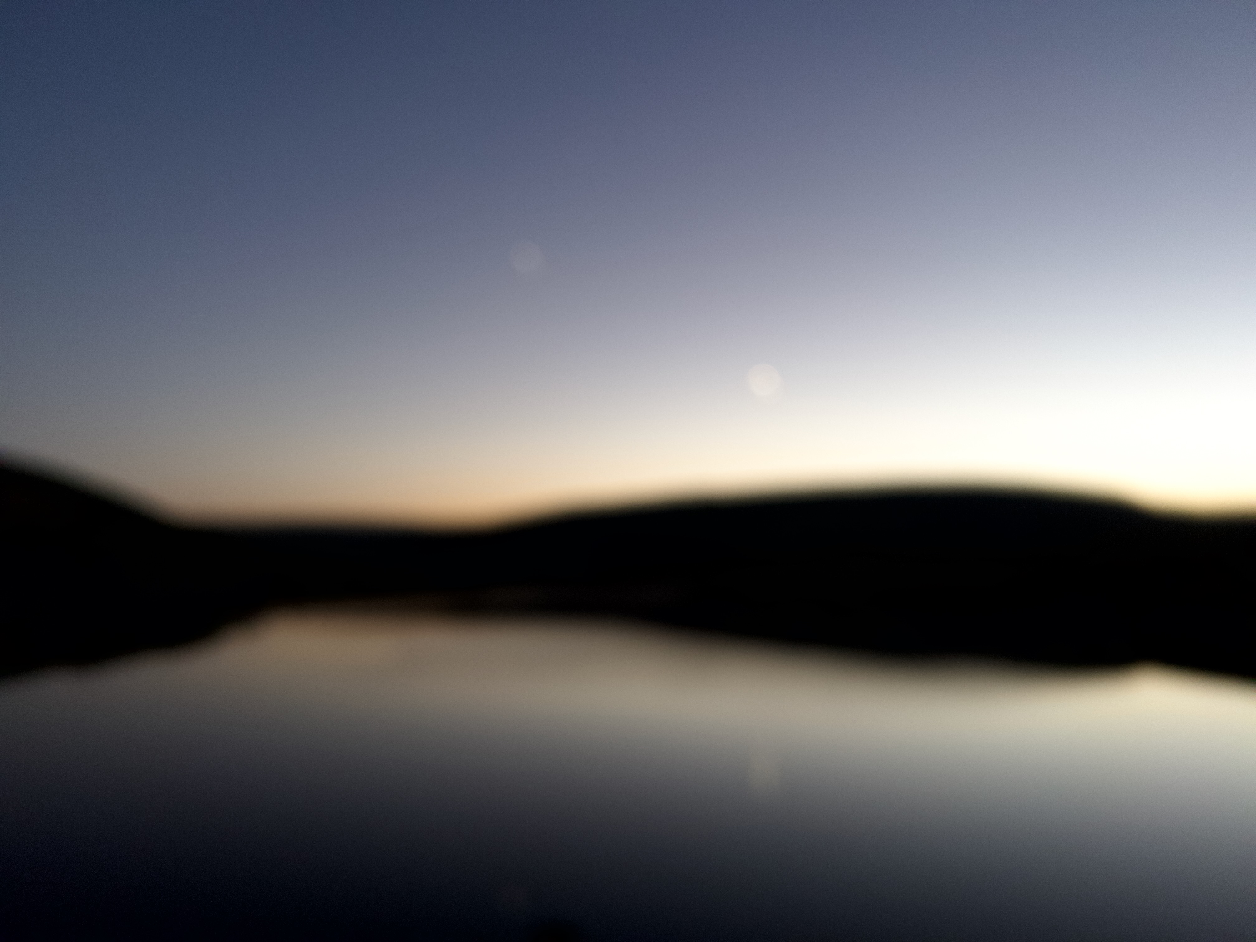 A peaceful mountain valley and lake at dusk